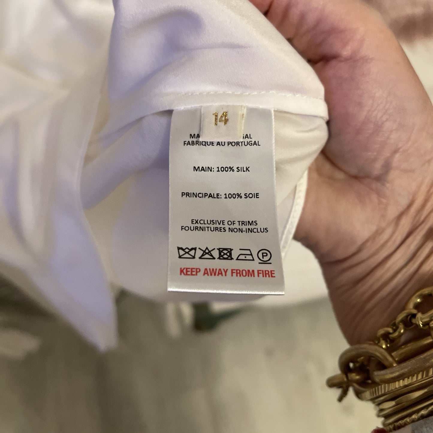 Elegant cream silk blouse by The Vampire’s Wife, featuring a high neck with tie detail, long puffed sleeves, and ruffled cuffs—perfect for designer vintage fashion. 100% SILK