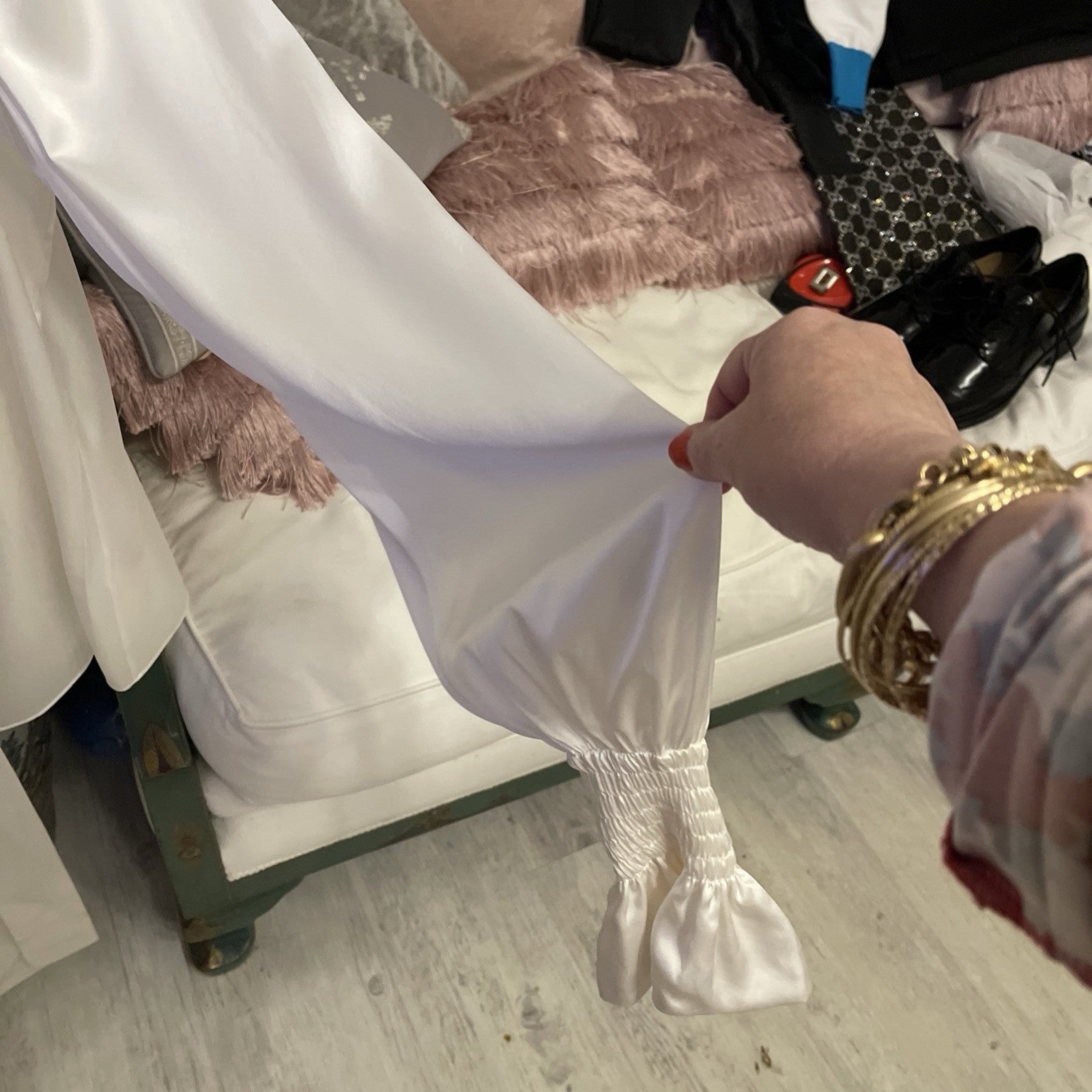 Elegant cream silk blouse by The Vampire’s Wife, featuring a high neck with tie detail, long puffed sleeves, and ruffled cuffs—perfect for designer vintage fashion cuff close up