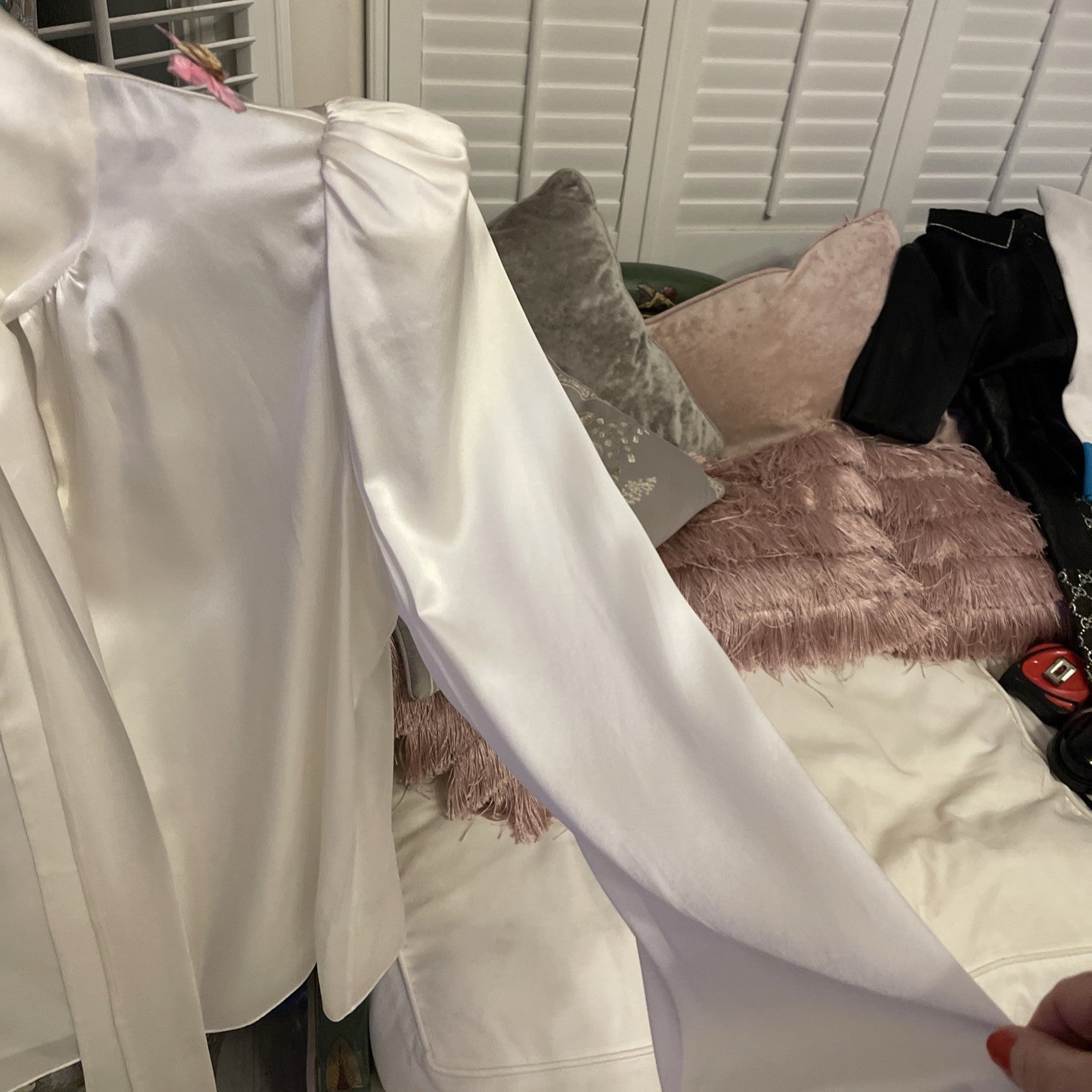 Elegant cream silk blouse by The Vampire’s Wife, featuring a high neck with tie detail, long puffed sleeves, and ruffled cuffs—perfect for designer vintage fashion.